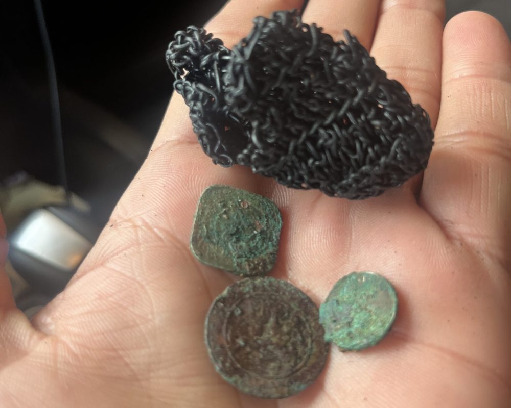 Kayakers paddling toward Sea Glass Island during a colorful sunset in Aruba